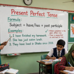Teacher explaining present perfect tense formula and examples on a classroom whiteboard with have has and past participle structure